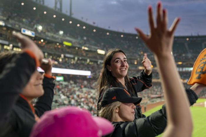 A student smiles at the SF Giants baseball game