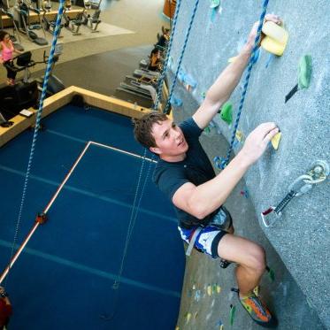 student climbing the wall