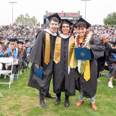 Graduating students standing together smiling