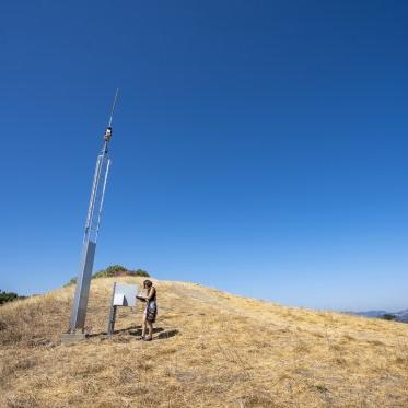 A student doing research atthe top of a hill