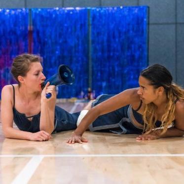 Two dancers on floor.  One with megaphone.