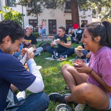 Students eatting lunch in a circle laughing