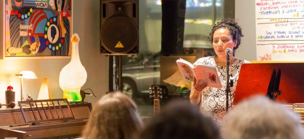 A writer performs her work on stage.