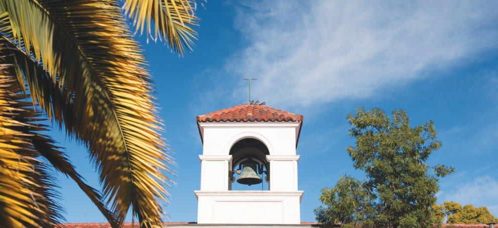 chapel in front of blue sky and foliage