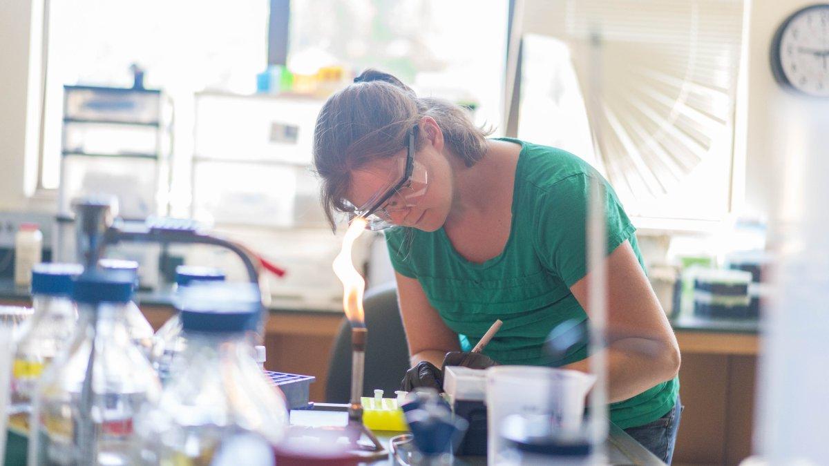 Student in a chemistry lab writing down notes